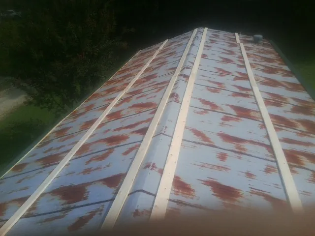 Rusted metal roof panels with new wood purlins before replacement — Storm Damage Roof Repair in Lilesville by Roofing Brothers